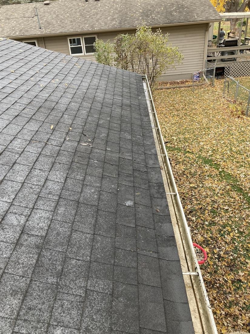 The same gutter run completely cleared and flushed after cleaning